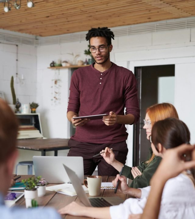 Young professionals engaged in a brainstorming session in a modern office setting.