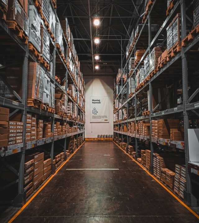 A well-organized warehouse aisle with stacks of goods on industrial storage racks, ensuring efficient logistics.